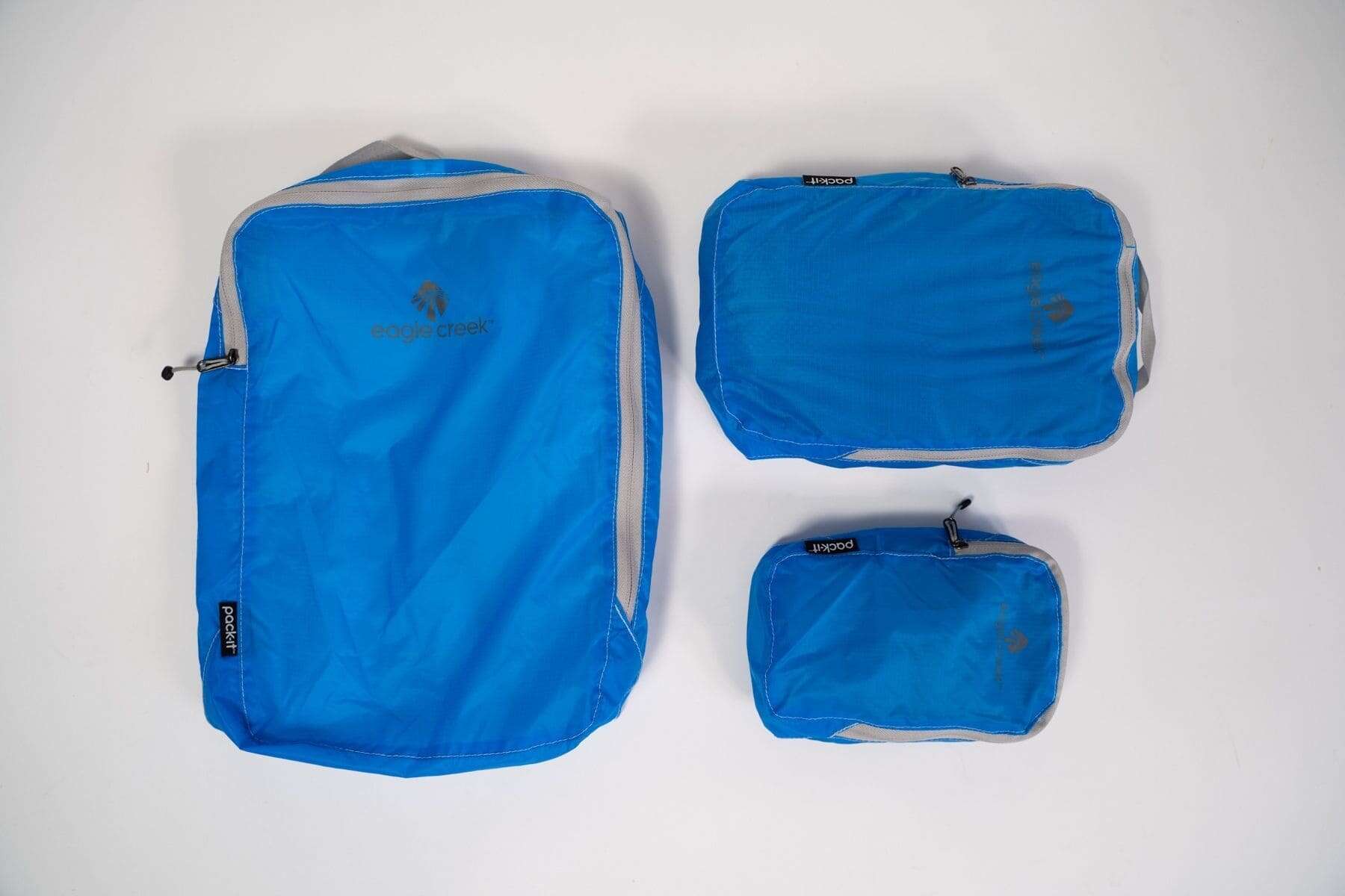 Flat lay of the Eagle Creek Pack It set. Three piece packing cube set in blue.
