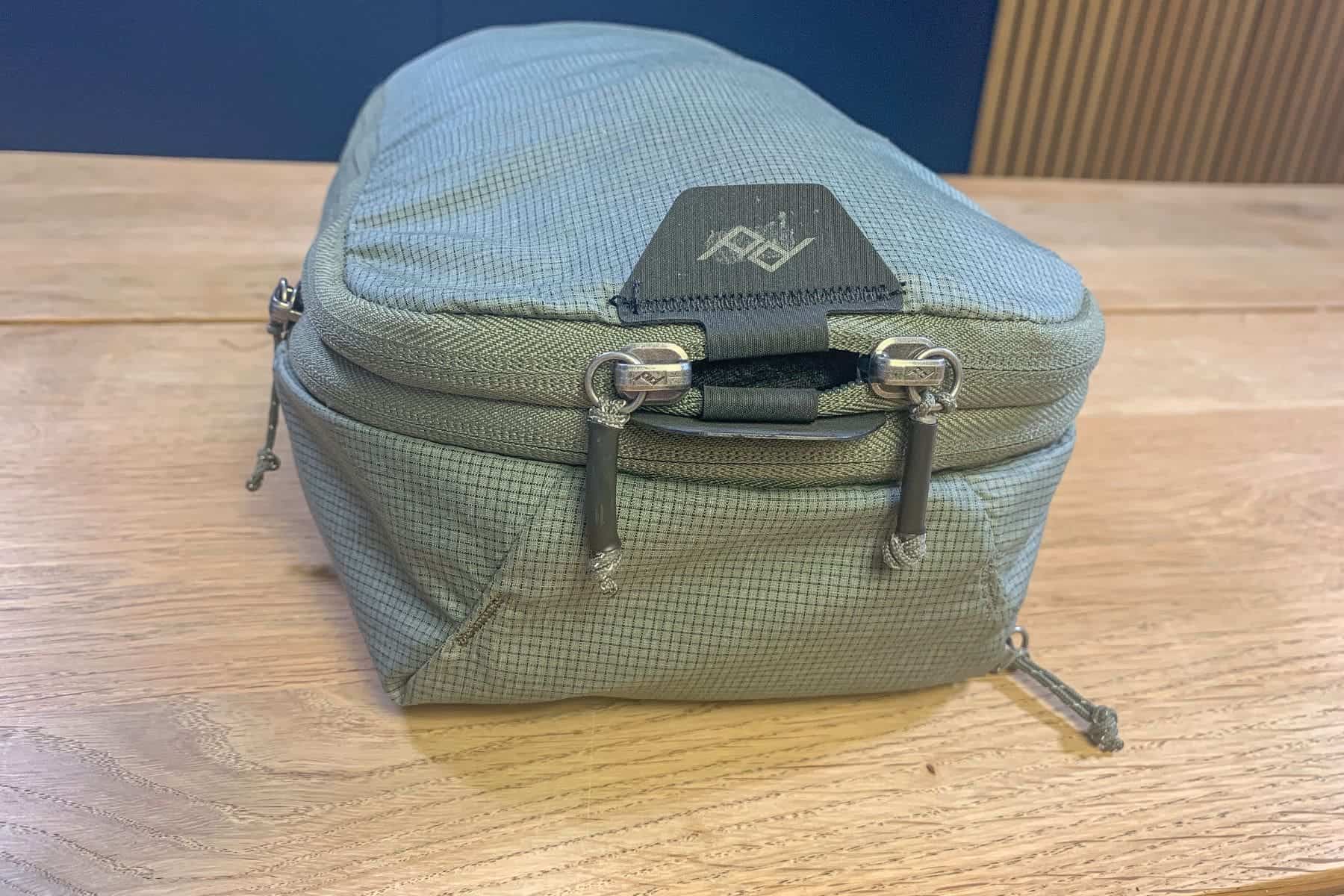 Small Peak Design packing cube. Close up of the two pull tabs in front.