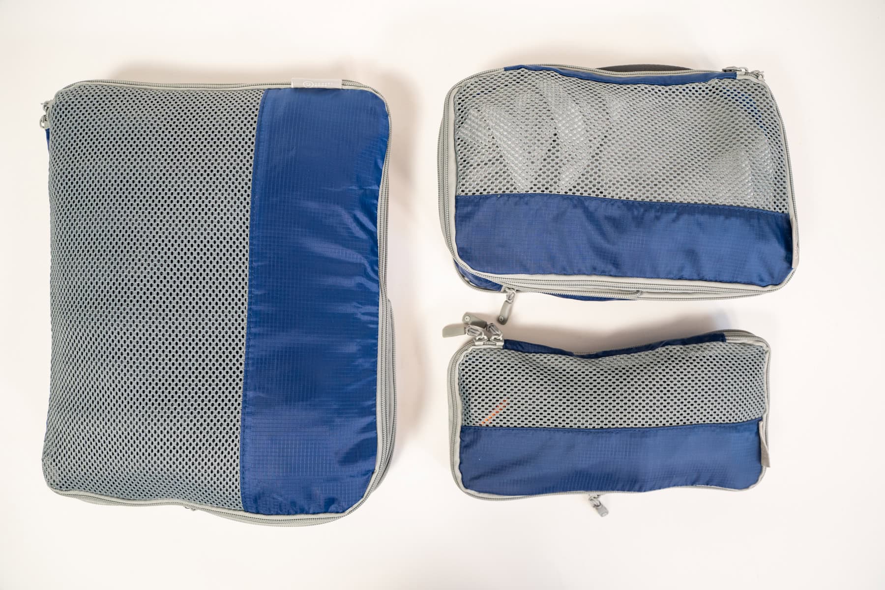 Flat lay of a blue Travel Dude packing cube set in small, medium and large.