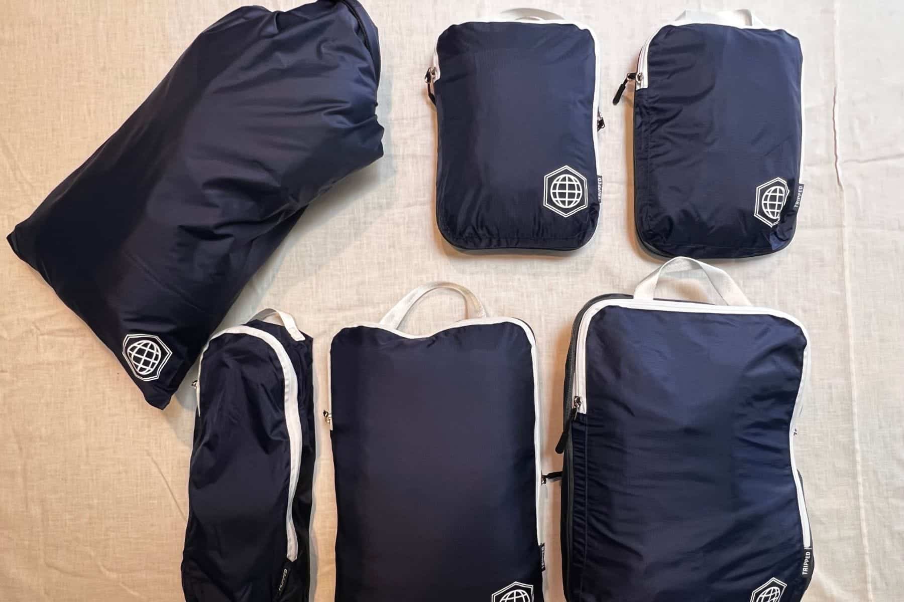 The Tripped compression packing cubes six-piece set flat lay.